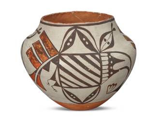 1175 An Acoma Pueblo polychrome pottery olla Early/mid-20th century Marked to underside: ACOMA / N. MEXICO The three-color jar with orange and black figural motifs on a white slip ground above a terracotta wash and slight puki indentation 6.75" H x 9" Dia. Estimate: $200 - $400