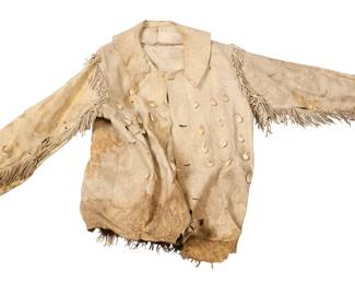 1364 A Plateau/Plains style fringed hide coat Mid-20th century The short coat with collar and lace-up front, the front adorned with imitation elk teeth, and with short fringing to shoulders, sleeves and hem Approximately 30" L x 23" W (across back at underarms); sleeves: 24" L Estimate: $500 - $700