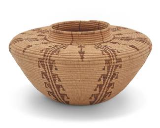1008 A Panamint Shoshone bottleneck basket Early 20th century; Great Basin The coiled basket with partial rim ticking above a wide, flat shoulder issuing seven hooked columns alternating with arrows 4.625" H x 8.375" Dia. Estimate: $1,500 - $2,000