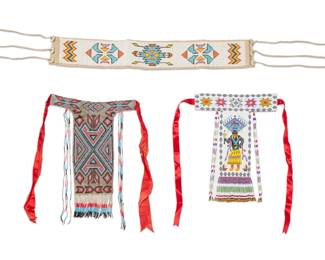 1386 Three Southwest beaded adornments Late 20th century Comprising a beaded hide sash with elaborate geometric motifs and chevrons, mounted with antler accents, and two beaded necklaces, one depicting an Apache Ga'an dancer, the other with geometric motifs 3 pieces Larger necklace: 17.5" H x 11.75" W; Smaller: 14.5" H x 11.25" W; Sash: 28" L Estimate: $400 - $600