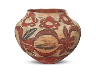 1314 An Acoma or Laguna Pueblo polychrome pottery olla 19th century The three-colored jar with red and lack banded foliate motifs on a white slip ground above a terracotta wash and puki indentation 5.25" H x 6.875" Dia. Estimate: $400 - $600