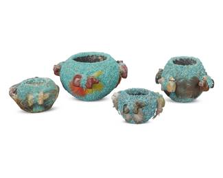 1319 Four Zuni Pueblo turquoise encrusted pottery fetish jars Mid/late 20th century Each with ground turquoise applique and mounted with carved stone fetish animals and feathers, two with fetishes placed inside the jar 4 pieces Largest: 2.125" H x 3.5" W x 3.375" D; Smallest: 1.25" H x 2.375" W x 2.25" D Estimate: $200 - $400