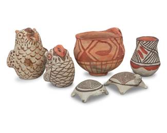 1318 A group of six small Southwest Pueblo pottery items 20th century One turtle signed: Lucy M. Lewis; the other: ACOMA, N.M. Comprising two Zuni owl figures, a three-color jar, handled cup, and two Lucy M. Lewis (1890-1992, Acoma Pueblo) turtle figures 6 pieces Cup: 4" H x 5.5" W x 4.5" D; Larger turtle: 1.5" H x 3.5" W x 2.875" D; Larger owl: 4.375" H Estimate: $200 - $400