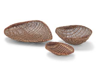 1347 Three Mono winnowing basketry trays Early/mid-20th century In graduated sizes 3 pieces Largest: 5.75" H x 18" W x 15.25" D; Smallest: 2.875" H x 8.375" W x 7.5" D Estimate: $200 - $400