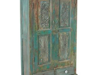 1418 A Santa Fe style painted wood cabinet 19th century The two cabinet doors carved with floral motifs, mounted with metal pulls and latch lock, opening to reveal a single shelf, above two drawers with later ceramic pulls 60" H x 36" W x 16" D Estimate: $400 - $600