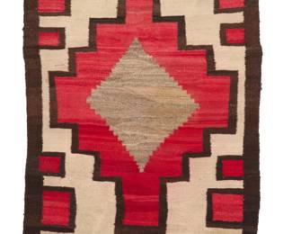 1095 A Navajo regional rug Early 20th century, Diné Woven in dark brown, cream, red, and natural grey wool, with central stepped diamond with another stepped diamond 50.5" H x 40" W Estimate: $500 - $700