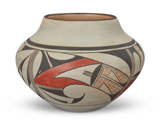 1294 Paqua [Frog Woman] Naha (c. 1890-1955, Hopi-Tewa) A polychrome pottery olla, early/mid-20th century Signed in slip with artist's frog cipher with straight-line 'toes' The wide shouldered jar with a band of red and brown avian motif panels on a cream slip ground 5.75" H x 8.25" Dia. Estimate: $500 - $700