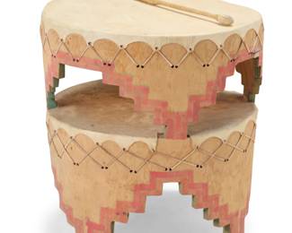 1280 A Pueblo style double drum and beater Mid/late 20th century The solid cottonwood drum with a double hide drum surface, carved with polychrome painted kiva step form, with a hide-wrapped beater 2 pieces Drum: 26" H x 25" W x 23.75" D; Beater without fringe: 17.25" L Estimate: $200 - $400