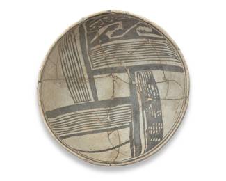 1324 An Anasazi black on white pottery bowl Circa 9th century CE-14th century CE With black fine-line and stepped motifs on a white slip ground 4" H x 9.75" Dia. Estimate: $300 - $500
