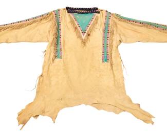 1365 A Plains style beaded hide powwow/war shirt Mid-late 20th century The long-sleeved shirt with multiple bands of polychrome striped beadwork in pink, blue, and yellow, with green pigment accents, and short fringing to sleeves, sides, and neckpieces, with blue wool blanket cloth trim to neck opening and cuffs, and open sides with hide laces, with natural shaped hem. Approximately 38" L x 22" W (across front at underarms); sleeves: 22" L Estimate: $200 - $400