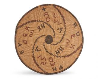 1058 An Apache polychrome basketry bowl Early 20th century; Southwest United States The coiled bowl with four radiating arms issuing from a black center with randomized floating letters 3" H x 10.25" Dia. Estimate: $600 - $800
