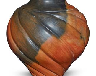 1073 Samuel Manymules (b. 1963, Navajo/Diné) A redware pottery jar, 1990s Incised to underside: SM / DINÉ The melon swirl vase with fire clouding throughout 8.5" H x 7.75" Dia. Estimate: $600 - $800