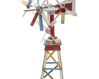 1338 A Folk Art painted wood windmill whirligig 20th century The windmill/weathervane with four articulating propellers centering a larger propeller, all swiveling on raised and tapered truss-form base 65.5" H x 40" W x 35.5" D Estimate: $300 - $500
