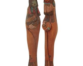 1403 Dan Bert (b. 20th century, Navajo/Diné) Two polychrome carved cottonwood katsinas, mid/late 20th century Each incised with title, artist's bear claw cipher, and: D. Bert Comprising a "Hano Mana" and a "Kachin Mana" 2 pieces Hano: 13" H x 2.75" W x 2.625" D; Kachin: 14.375" H x 2.5" W x 2.5" D Estimate: $200 - $400