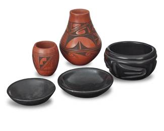 1304 A group of Southwest Pueblo pottery vessels Five works: Alberta Adams (b. 20th century) A redware tall neck jar, mid/late 20th century Signed to underside: A. Adams With banded black geometric motifs on a red slip ground 6.125" H x 4.75" Dia. Dora Tse Pe (1939-2022, San Ildefonso Pueblo) A blackware dish, late 20th century Incised to underside: Dora 1.5" H x 5.125" Dia. Brandon Gonzales (b.1983, Santa Clara Pueblo) A blackware dish, 1988 Incised to underside: 7/88 / Brandan Gonzales / 4 yrs old 1.625" H x 4.25" Dia. A small redware vase, late 20th century Signed to underside, possibly reading: Annabelle With black banded geometric motifs on a red slip ground 3.375" H x 2.75" Dia. A blackware bowl, mid/late 20th century Signed in pencil illegibly to underside With deeply carved bord wing motifs 3.125" H x 5.375" Dia. 5 pieces Estimate: $200 - $400