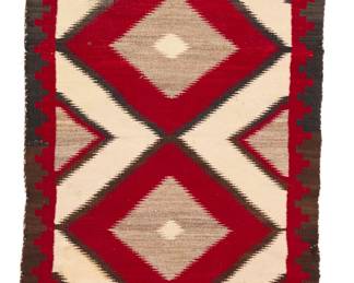 1096 A Navajo regional rug Early 20th century, Diné Woven in dark brown, cream, red, and natural grey/brown wool, with stacked serrated diamonds within a stepped border 55.5" H x 36" W Estimate: $500 - $700