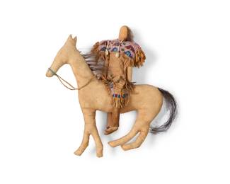 1398 A Plains beaded hide doll on horse Early 20th century With polychrome beaded geometric designs to garments and shell earrings, with horsehair tail 10" H x 9" W x 2.5" D Estimate: $200 - $400