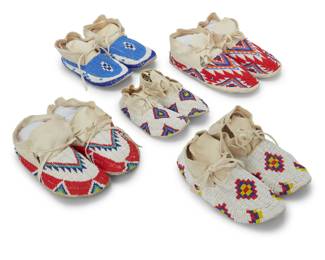 1354 Five pairs of Plains beaded hide moccasins Late 20th/early 21st century Each with polychrome beaded geometric designs 10 pieces Largest: 10.375" L x 4.125" W; Smallest: 7.375" L x 3.375" W Estimate: $200 - $400