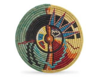 1067 A Navajo polychrome basketry tray Late-20th century, Diné Likely the work of Angelina Holiday (20th/21st century), depicting a stylized Yei 1.25" H x 13.625" Dia. Estimate: $300 - $500