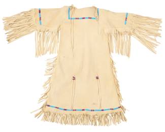 1363 A Plains style beaded hide dress Late 20th/early 21st century With beaded bands at neckline, sleeve ends, and bottom of dress, fringe elements at sleeves, sides, and hem, and beaded tassels at center front and back 38.5" L x 15.5" W (across front underarms); sleeves: 9" L; with fringe: 19" L Estimate: $200 - $400