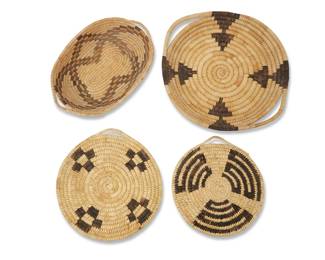 1062 Four Papago basketry trays Early/mid-20th century, Tohono O'odham; Southwest United States Four coiled trays, comprising a larger circular handled tray with stacked triangles, an oval two-handled polychrome tray with four conjoined diamonds, and two flat trays each with single handle and geometric designs 4 pieces Largest: 1.5" H x 12.625" W x 11.5" D; Oval: 1.5" H x 10.75" W x 7.375" D Estimate: $100 - $200