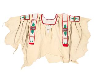 1366 A Plains style beaded hide powwow/war shirt Late 20th/early 21st century The pullover single hide shirt with polychrome white, green, and white beadwork panels in geometric designs and multiple horsehair tassels with metal cones, with partial white jersey lining 26" H x 45" W approximately Estimate: $200 - $400