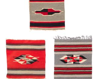 1415 Three Chimayo table textiles Mid-20th century; New Mexico Each woven in red, natural grey, black, and cream wool, depicting a central floating geometric element with opposed banding, one converted into a pillowcase with sewn backing 3 pieces Largest: 20.75" H x 19.25" W; Case: 18.75" H x 17" W Estimate: $200 - $400