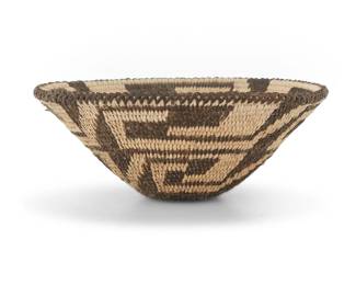 1238 A diminutive Pima basket Early 20th century, Akimel O'odham; Arizona The coiled basket with braided rim above swirling stepped designs 1.5" H x 3.75" Dia. Estimate: $300 - $500