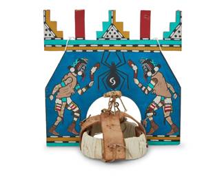 1405 A Hopi polychrome wood dance tableta Late 20th century Painted with katsina dance figures and a spider, with feather accents at top, mounted to a hide and fabric headpiece 14.75" H x 14.75" W x 10" D Estimate: $200 - $400