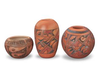 1307 Three Hopi Pueblo polychrome redware pottery jars Three works: Emma Naha (b. 20th century, Hopi-Tewa) Two reedware vessels, mid/late 20th century Each signed to underside: EMMA NAHA With banded geometric motifs 2 pieces Taller: 3.625" H x 2.375" Dia. Marilyn Shula Sakeva (1955-2019, Hopi-Tewa) A redware jarlet, mid/late 20th century Signed: Marilyn Sakeva With banded geometric motifs 2" H x 2.875" Dia. 3 pieces total Estimate: $200 - $400