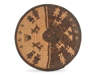 1057 A Yavapai night and day figurative basketry tray Early 20th century; Southwest United States The coiled tray with rim band above human and animal figures and elements of the sky, one half rendered in negative 2.5" H x 8" Dia. Estimate: $600 - $800