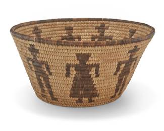 1061 A Papago figurative basketry bowl Early/mid-20th century, Tohono O'odham; Southwest United States The coiled bowl with a rim band above alternating male and female forms 6.125" H x 12.375" Dia. Estimate: $300 - $500