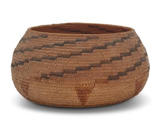 1038 A California Mission polychrome basketry bowl Early 20th century; Southern California The coiled bowl with stepped arms radiating to rim above inverted triangular floating elements to base 4.875" H x 9.875" Dia. Estimate: $600 - $800