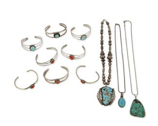 2289 A large group of Southwest style jewelry Mid/late 20th century One pendant etched: W.W. / [tipi pictograph] A large group comprising a chunky set turquoise pendant with applied silver feather accents suspended from a single short strand of silver beads, together with two further set turquoise pendants, each on an associated silver chain, as well as eight cuff bracelets, in single, double or triple wire, each with a single set turquoise or coral cabochon 11 pieces Cuffs: 6.25" inner C to 5.5" inner C; Pendants: 16.25" L x 2" H; 2" H & 1.5" H 194.7 grams gross Estimate: $200 - $400