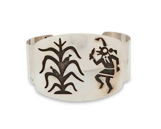 2202 A Hopi Pueblo style sterling silver overlay cuff bracelet Late 20th century Stamped: Sterling A chunky cuff with large overlay plaque featuring a large katsina clown dancer and corn stalk motifs 8" total inner C x 2" H, gap: 1.5" 79.2 grams Estimate: $200 - $400