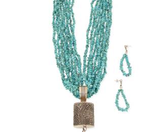 2166 A set of Pueblo style silver and turquoise jewelry Late 20th century Unmarked Comprising a ten-strand turquoise necklace suspending a large sandcast sterling silver cylindrical barrel pendant with cone dangles, and a pair of matching earrings 4 pieces Necklace: 24" L x 5" H x 1.375" Dia.; Earrings: 2.5" H 251.2 grams gross Estimate: $600 - $800