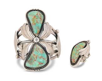 2016 A set of Navajo sterling silver and turquoise jewelry Early/mid-20th century, Diné Cuff stamped: CT [or C over T] Two works comprising a large chunky five wire cuff with two set slab turquoise stones and heavily stamped elaborate applied feather accents, together with a matching ring 2 pieces Cuff: 6.125" total inner C x 3.625" H, gap: 1.25"; ring size: 7.5, 1.75" H 146.8 grams gross Estimate: $700 - $900