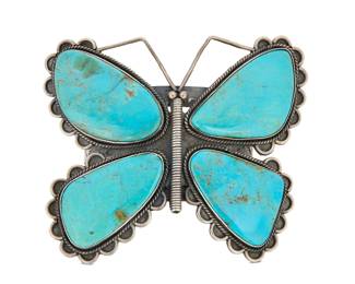 2058 A large Federico Jimenez turquoise butterfly cuff bracelet Federico Jimenez (b. 1941, Mixtec) Late 20th/21st century Stamped: JF [conjoined] / Sterling The three wire sterling silver butterfly cuff with four set slab turquoise stones, scalloped edges and and stampwork to the shoulders 7" total inner C x 3.5" H x 4.25" W, gap: 1.25" 157.0 grams gross Estimate: $800 - $1,200