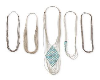 2271 A group of Southwest liquid silver necklaces Late 20th century Two marked for sterling Comprising five multistrand silver bead necklaces, including one interwoven in a lattice pattern with turquoise beads, and one with an asymmetrical arrangement of turquoise beads to one side, each with silver cone tip hook closures 20" L to 18.5" L 118.4 grams gross Estimate: $300 - $500
