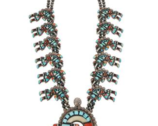 2061 A Federico Jimenez Rainbow Guardian multistone inlay squash blossom necklace Federico Jimenez (b. 1941, Mixtec) Late 20th/21st century Stamped: JF [conjoined] / Sterling A double strand necklace with twelve sterling silver mosaic inlay Rainbow Guardian 'blossoms' suspending a large Rainbow Guardian 'naja', each with multistone inlay including turquoise, onyx, and spiny oyster 26.5" to 29" L x 3.75" H 282.6 grams gross Estimate: $800 - $1,200