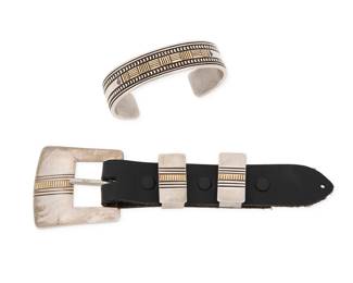 2094 A group of Harris Joe Navajo sterling silver and 14K gold jewelry Harris Joe (b. 20th century, Diné) Late 20th century Each stamped: Harris Joe [script] / Sterling / 14K Comprising a Ranger set of a buckle and two belt keepers, each with banded line and gold accents, and mounted to short black leather strap, together with a similar design cuff bracelet with incised banding and 14K gold overlay accents 4 pieces Buckle: 2" H x 2" W; each keeper: 1" H; Cuff: 7" inner C x 0.75" H, gap: 1.375" 116.1 grams gross Estimate: $600 - $800