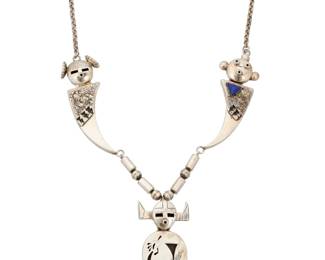 2235 A Southwest sterling silver kachina necklace Late 20th/21st century Stamped with unknown buffalo cipher / Sterling A chunky silver link figural necklace with silver overlay accents featuring two stylized katsina sculptural links, one with set lapis lazuli, both suspending a detachable katsina shadowbox pendant with Pueblo and corn motifs 23.25" L x 3.5" H 127.1 grams gross Estimate: $600 - $900
