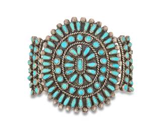 2080 A Victor Moses Begay Zuni sterling silver and petit point turquoise cuff bracelet Victor Moses Begay (b. 20th century, Zuni Pueblo) Mid/late 20th century Stamped: VMB A delicate three wire silver cuff with a cluster and row set petit point turquoise medallion 6" total inner C x 2.125" H, gap: 1" 58.3 grams gross Estimate: $500 - $700