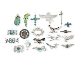 2295 A large group of Southwest style silver brooches Mid/late 20th century Variously marked for maker and/or for sterling: Douglas Etsitty / H. Monte / D / HIJE / J Ritter / F / E / HANDMADE Comprising multiple brooches and five pendant/brooches, all in various stones such as turquoise, coral, and shell, and in various styles including cast silver conchos, multistone stone inlay, cluster set, and single set stones, and featuring various motifs such as roadrunners, eagle, and a parrot, Kokopelli, and Eagle dancer, and a sword, as well as a sterling silver set turquoise cross pendant 20 pieces Largest: 2.5" H x 4" W; Smallest: 1.125" H x 1.5" W 255.9 grams gross Estimate: $400 - $600