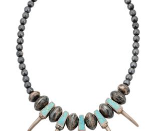 2195 A Southwest sterling silver and turquoise 'bear claw' style necklace Mid-20th century Unmarked A short chunky single strand necklace with sterling silver and turquoise inlay 'bear claws' alternating with graduated sterling silver beads 20" L x 1.875"H 92.5 grams gross Estimate: $400 - $600