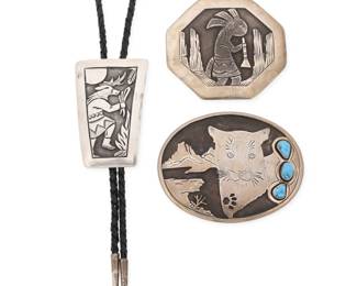 2254 A group of Navajo sterling silver jewelry Late 20th century Three works:  Robert Becenti Jr. (Diné), 1949-2001) Two Navajo sterling silver jewelry items Each marked: B.E.T / [pipe picto] / Sterling Comprising a trapezoid bolo tie with silver overlay figural katsina dancer motif, on a black cord with silver tips, and a large octagonal belt buckle with katsina figure in a landscape, 2 pieces Bolo slide: 3" H x 2" W; cord: 37" L; Buckle: 3" H x 3.375" W  Fritson Toledo (b. 1961, Diné) A Navajo sterling silver overlay belt buckle Stamped: Toledo / Sterling A chunky oval belt buckle featuring a mountain lion in a landscape, with three shadowbox set turquoise stones to one side 3" H x 3.875"W, belt bar: 1.5"  3 pieces total 210.6 grams gross Estimate: $500 - $700