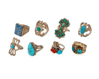 2308 A group of Southwest silver and stone set rings Mid/late 20th century One stamped: sterling; one etched: BB / 12K-GF Eight rings in various styles with set stones including a cluster set Zuni-style ring, a set coral and turquoise eagle ring, a 12K gold-filled band with set turquoise and applied feather accents, and a sodalite mosaic inlay ring with eagle motif shoulders, as well as four rings with single set turquoise 8 pieces Ring sizes: 10 to 7 66.0 grams gross Estimate: $300 - $500