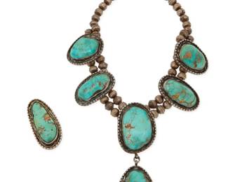 2188 A set of Southwest sterling silver and turquoise squash blossom jewelry Mid-20th century Each etched with bird picto / 44 Hawk Comprising a chunky double strand collar necklace with four stylized set turquoise blossom plaques suspending a single drop pendant, as well as a matching set turquoise ring 2 pieces Necklace: 15" L x 3.75" H; Ring size: 7; 2" H 176.2 grams gross Estimate: $600 - $800