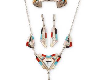 2074 A group of Zuni Pueblo sterling silver and multistone inlay jewelry Late 20th/21st century Three works: Ronnie Calabaza (b. 20th century, Zuni Pueblo) A set of Zuni sterling silver and multistone inlay jewelry Each stamped: RC / Zuni NM A modernist style chain link necklace with elaborate raised and edge inlay in turquoise, coral, shell, and mother of pearl, featuring a central triangular arrow pendant with dangle, suspended from two matching links and paperclip chains, with a pair of matching earrings 3 pieces Necklace: 19.25" L x 3.25" H x 2" W; Earrings: 2.74" H Martin & Esther Panteah (both b. 1946, Zuni Pueblo) A Zuni inlay cuff bracelet Stamped: Martin & Esther Panteah / MT Panteah / Zuni A chunky cuff with two bands of sculptural raised channel inlay in turquoise, coral, and shell 6.375" total inner C x 0.75" H, gap: 1.125" 4 pieces total 83.2 grams gross Estimate: $300 - $500