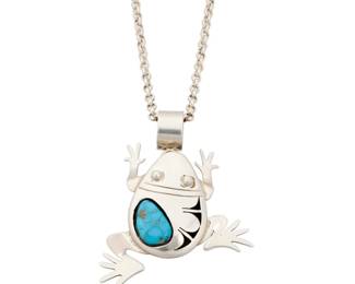 2140 A Bennie Ration Navajo sterling silver and turquoise frog necklace Bennie Ration (b. 1955, Diné) Late 20th/21st century Stamped: B.R. / Sterling / [talon picto] A small climbing frog figural pendant/brooch with set turquoise stone and incised silver geometric accents, suspended from a silver chain 2 pieces 22" L x 3" H x 2.25" W 50.2 grams gross Estimate: $500 - $700